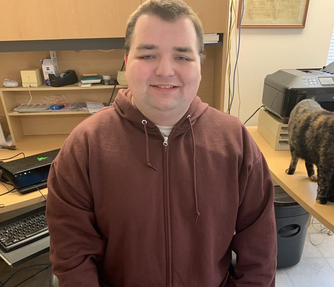 Mathew Kleinman sits in his home office.