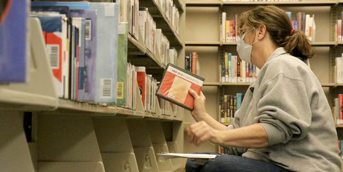Customer browses Sultan Library shelf